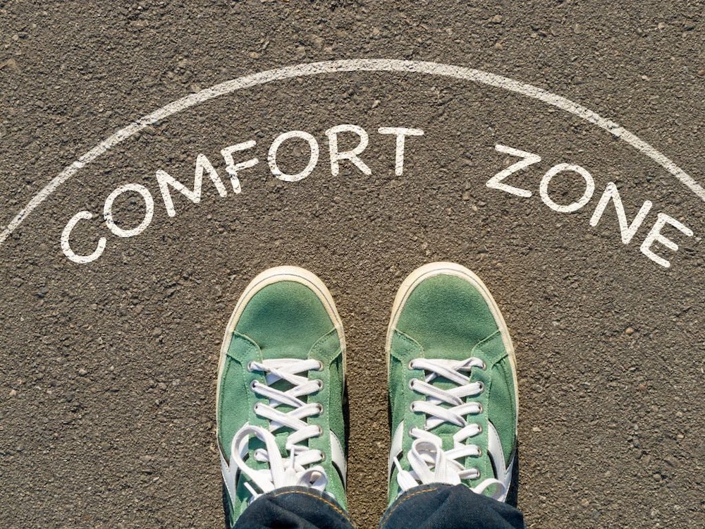 photo on top of the sneakers and the inscription comfort zone on the asphalt, the concept of personal private space